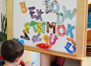 alphabet letters shaped like animals on classroom board